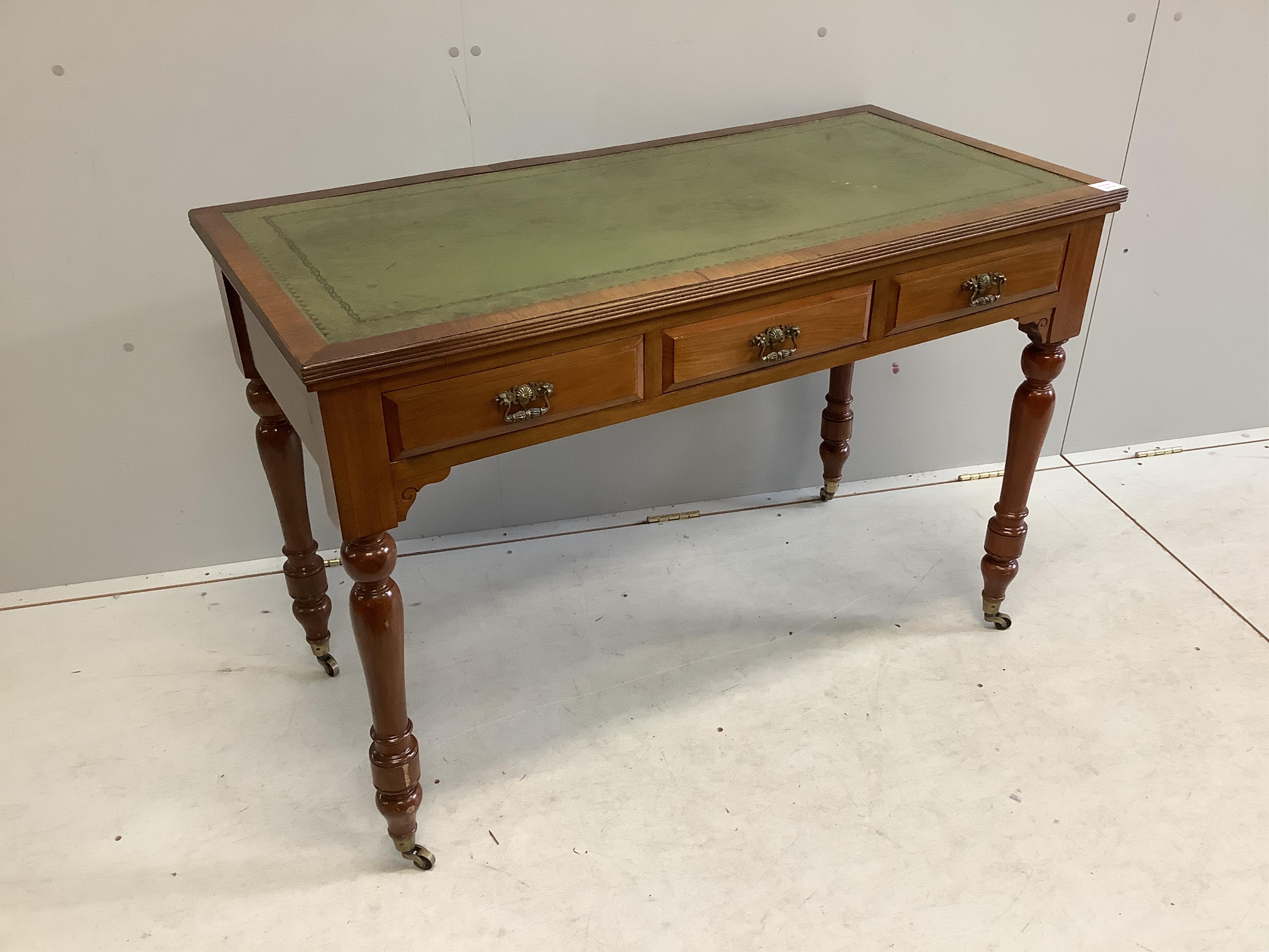 A late Victorian mahogany three drawer writing table, with an inset leather top, width 113cm, depth 55cm, height 77cm. Condition - fair to good, one piece of veneer detached but present